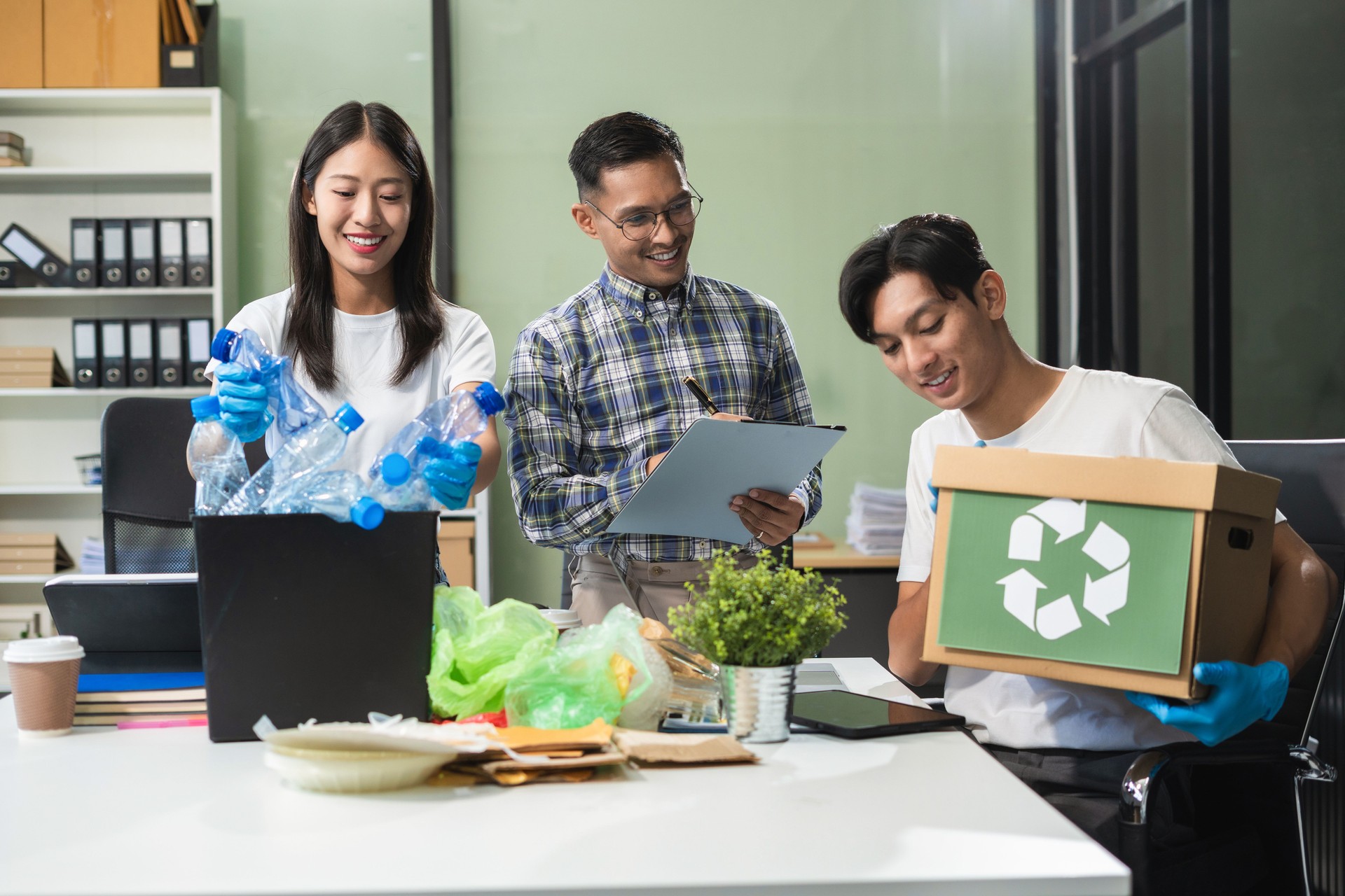 Business people working examining waste recyclable separation divided bin in the office, Sustainable development and innovation green business concept.