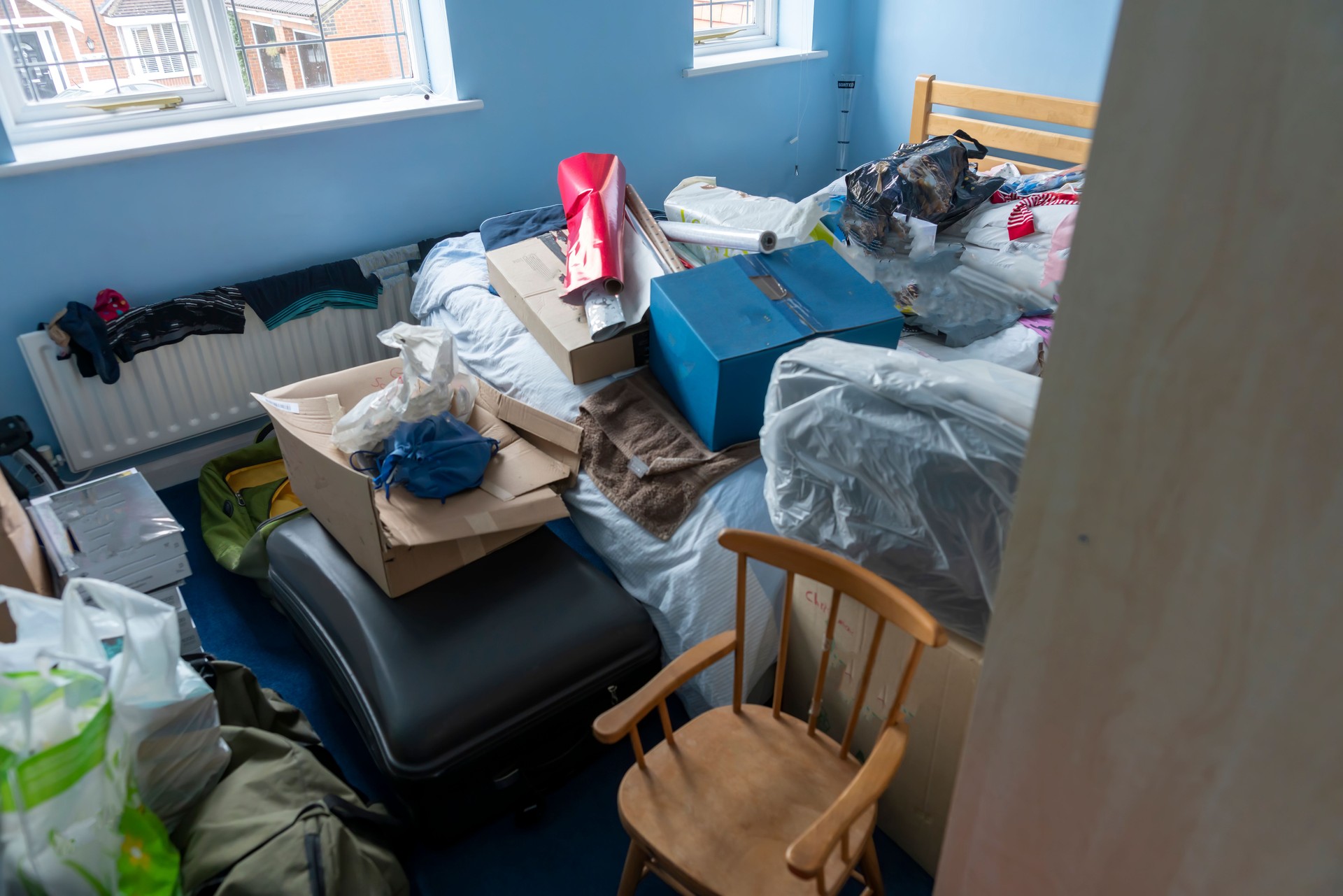 Bedroom cluttered by loft contents